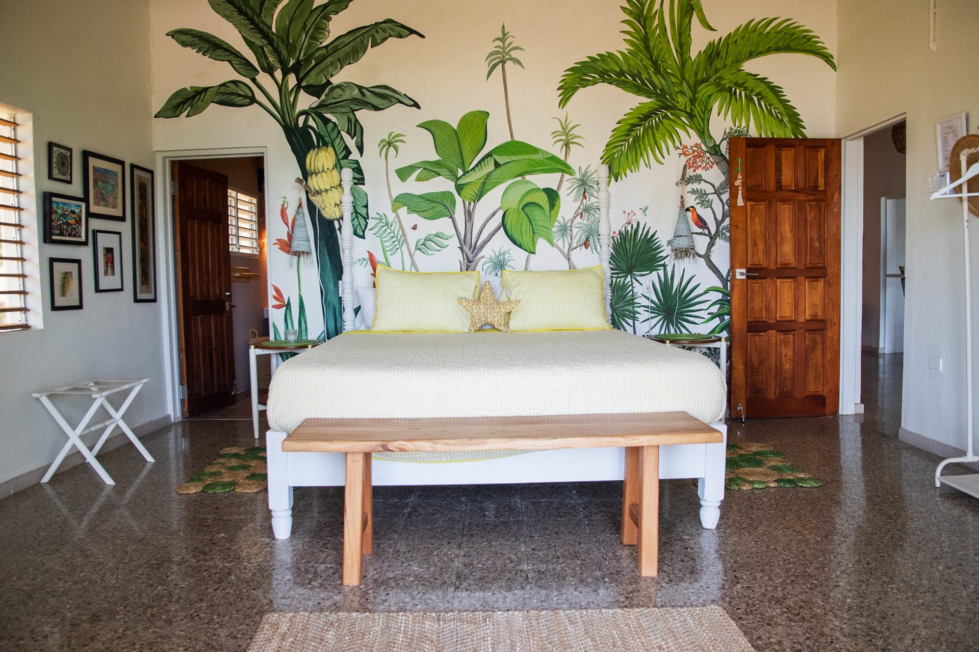Bright bedroom with tropical mural at therapy retreat in Jamaica.