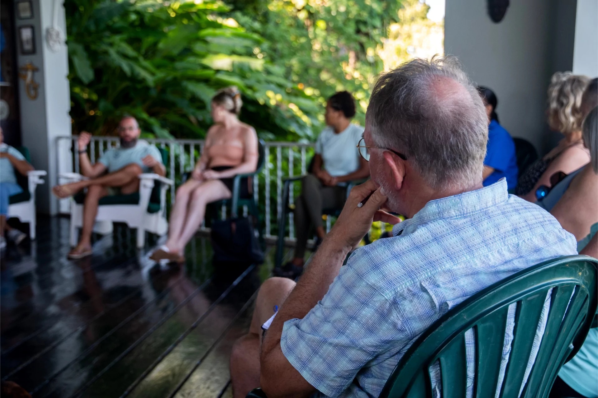Guests sit in a sharing circle on the veranda at our psilocybin retreat.