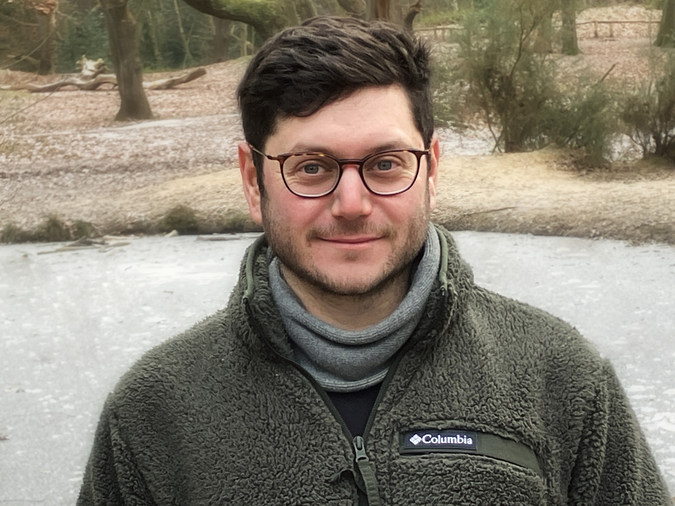 Sam Woolfe, content writer for MycoMeditations, standing by a frozen pond.