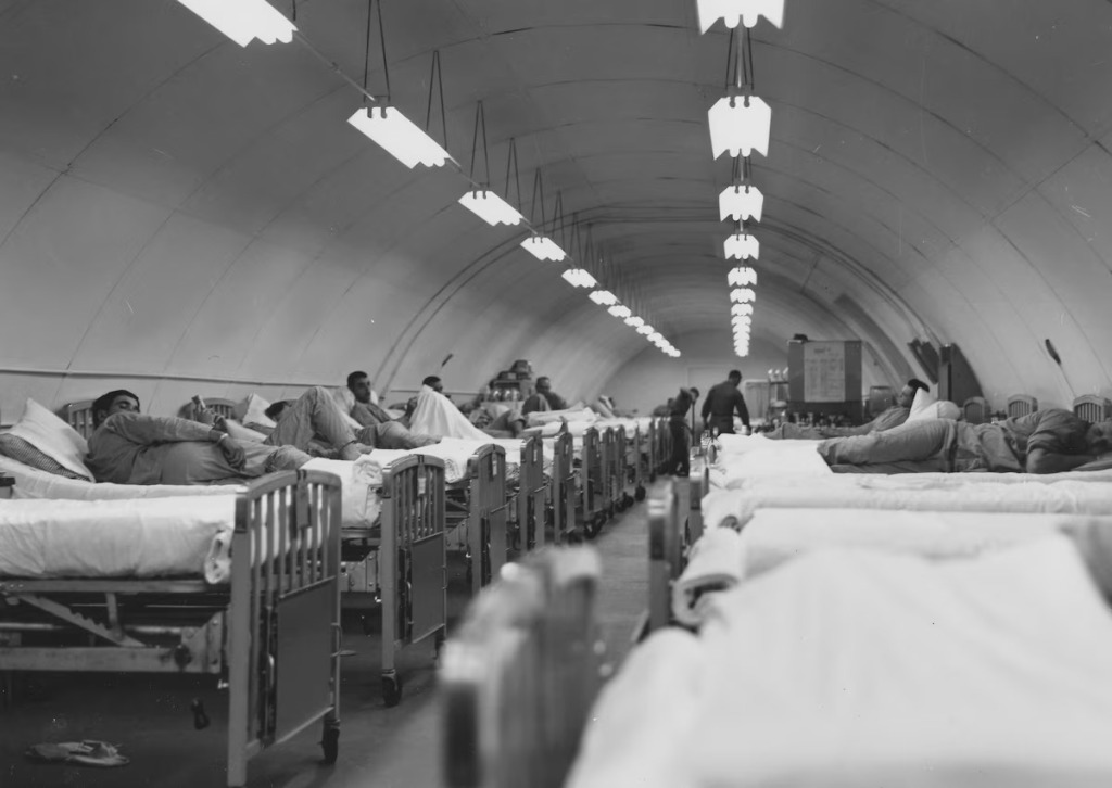 hospital beds with men laying on them during the vietnam war