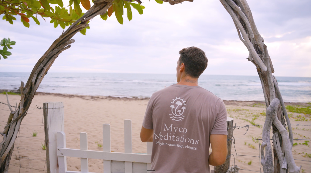 MycoMeditations owner, Mike Ljubsa, opening a gate to the beach at Rainbow Tree retreat location.
