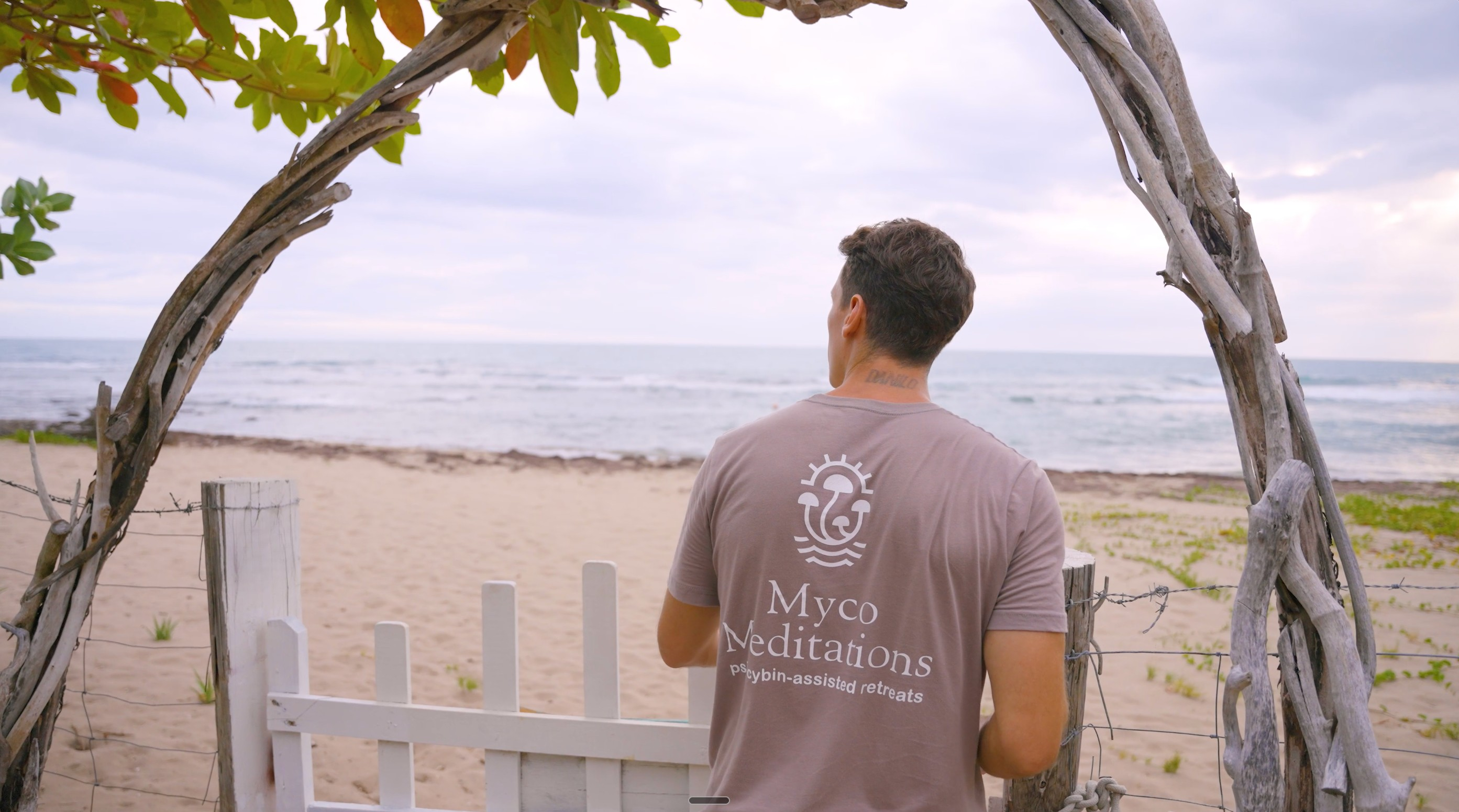 MycoMeditations owner, Mike Ljubsa, opening a gate to the beach at Rainbow Tree retreat location.
