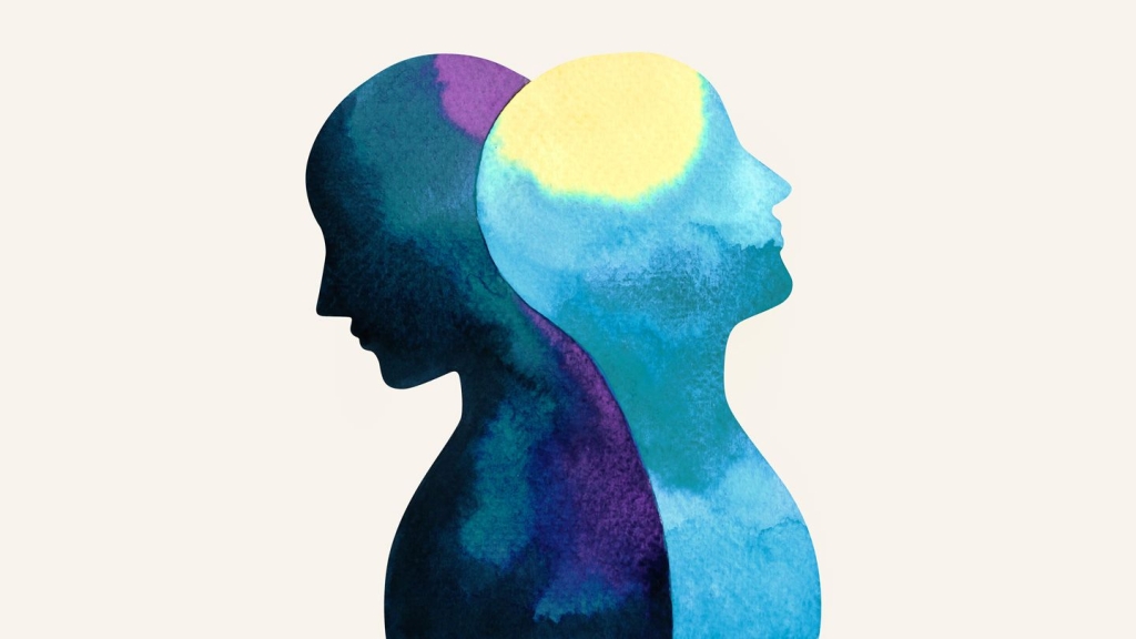 A graphic of two heads metaphorically depicting conflicted states of being to represent bipolar disorder.